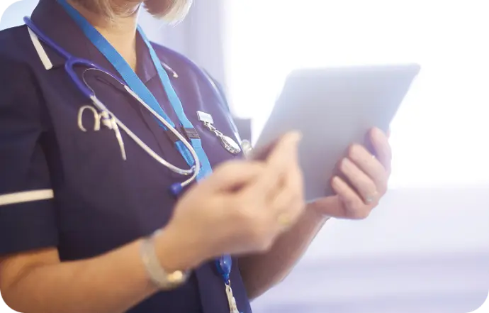 Healthcare professional using digital tablet for patient care management